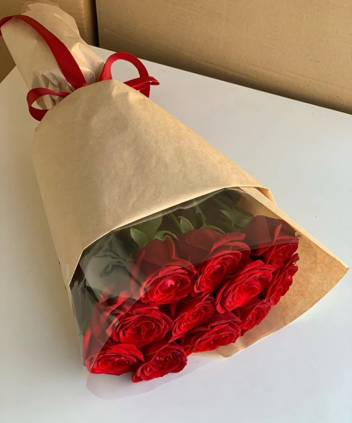Классический букет из 11 красных роз в крафте  with delivery to Pavlodar